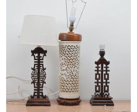 A pair of hardwood Chinese long life and happiness table lamps, one with a shade 38cm high, together with a pierced ceramic C