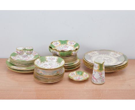 A large collection of Minto ceramic table ware items, the majority with  heightened gilt and central bird designs, some retai