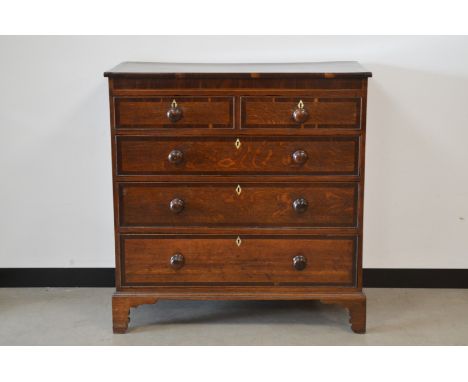 A Victorian oak crossbanded chest of drawers, two short drawers, over three graduated long drawers, replacement wooden handle