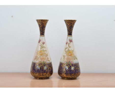 A pair of 20th century ceramic Carlton Ware vases, with floral designs, some minor condition issues to the rim, one marked to