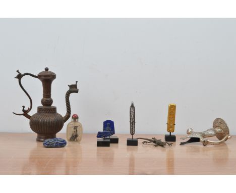 A collection of far eastern works of art, comprising a gilt token 9cm high, carved pieces of lapis lazuli, an Islamic sword h