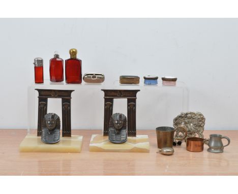 A collection of works of art, including silver topped coloured glass scent bottles, a pair of Egyptian themed art deco style 