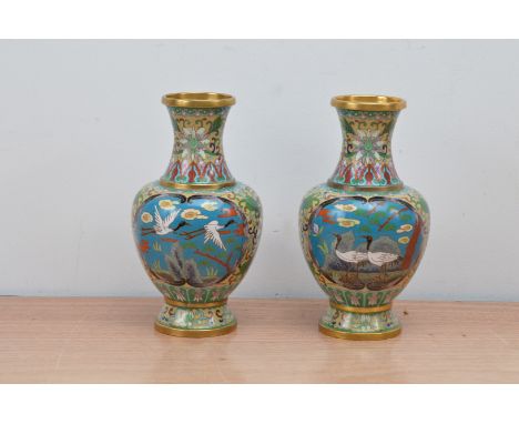 A pair of early 20th century Japanese decorative enamel and metal baluster vases, both depicting cranes, 21cm high, both with