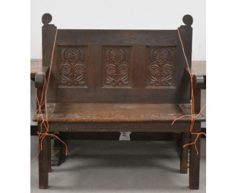 A 19th century and later carved oak settle/bench,  three carved panel back with carved seat and carved supports, AF, 115cm H 