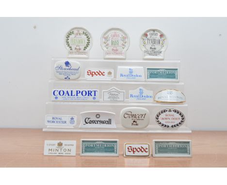 A collection of British ceramic advertising plaques, including Spode, Minton, Coalport, Poole Pottery, Royal Crown Derby, Por