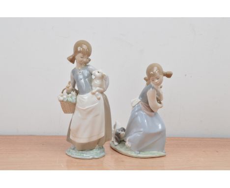 Two Llodra ceramic figurines, one of girl with a lamb, the other a girl with a dog, both marked to the undersides 25cm and 21