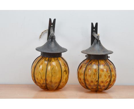 Two 20th century hanging garden lanterns, metal bracket with yellow/orange glass AF 28cm high (2) 