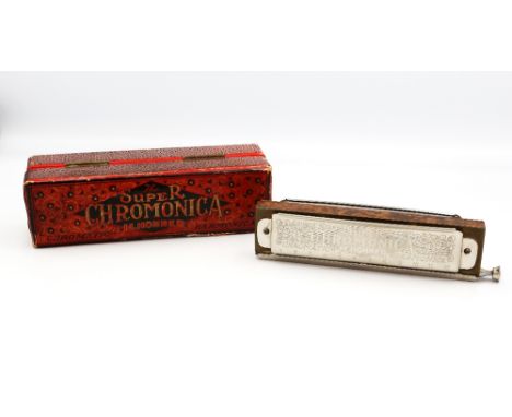 Hohner Super Chromonica in original fitted case. Wear to the case.