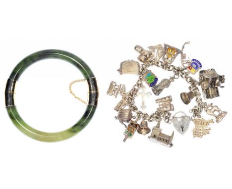 A GOLD MOUNTED NEPHRITE BANGLE AND A SILVER CHARM BRACELET