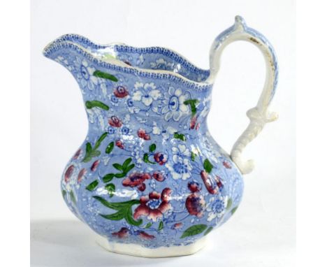 A BLUE PRINTED WHITE EARTHENWARE JUG WITH A FLORAL SHEET PATTERN AND HEIGHTENED IN PUCE AND GREEN ENAMEL, 21CM H, C1830