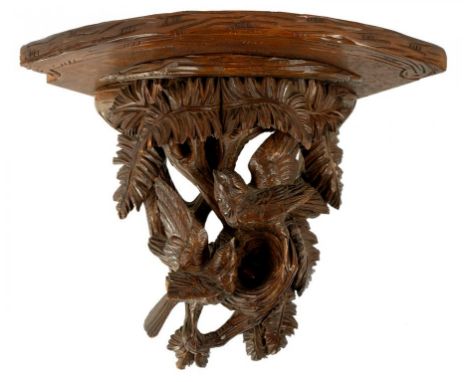 A SWISS 'BLACK FOREST' CARVED LIME WOOD CORNER WALL BRACKET, THE SHELF SUPPORTED BY BIRDS IN BRANCHES, 32CM H, LATE 19TH C