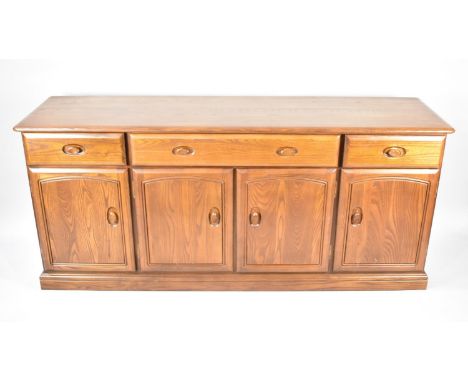 An Ercol Windsor Type Sideboard with Three Drawers and Cupboard Base, 180cms Wide