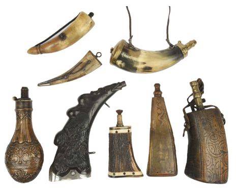 A collection of horn powder flasks, comprising: a 19th century German white metal mounted example, 26cm, carved to either sid