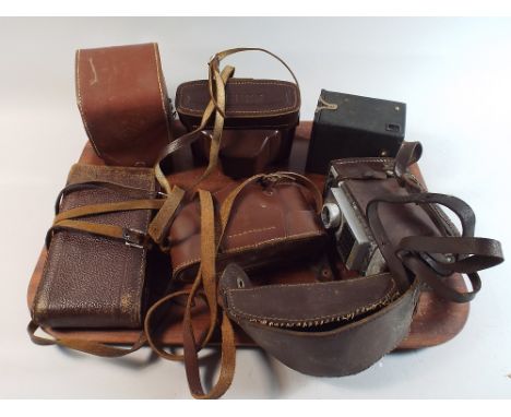 A Tray Containing Six Cased Vintage Cameras 