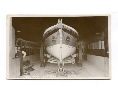 An album containing 34 postcards of Brighton and Hove, including photographic postcards titled 'Brighton, The Lifeboat', 'H.M