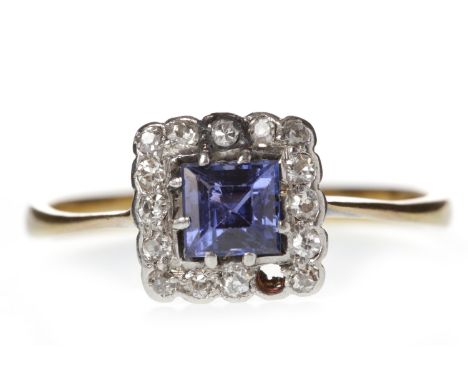 EARLY TWENTIETH CENTURY PASTE AND DIAMOND CLUSTER RINGset with a central square step cut paste with blue to purple tones, 4.6