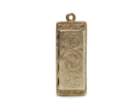 MID TWENTIETH CENTURY NINE CARAT GOLD HARMONICA MOTIF CHARMwith engraved decoration, 29mm long, 11.2g