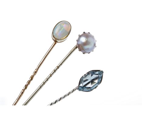 THREE EARLY TWENTIETH CENTURY PINSone set with an opal, one with a blue paste and the other with a single pearl, all unmarked