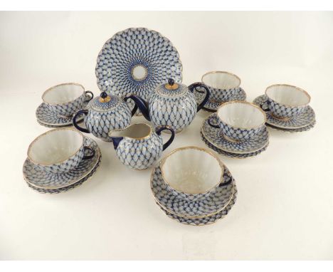 LOMONOSOV RUSSIAN PORCELAIN TEA SERVICE, in a cobalt net pattern heightened with gilt, comprising five cups, six saucers, six