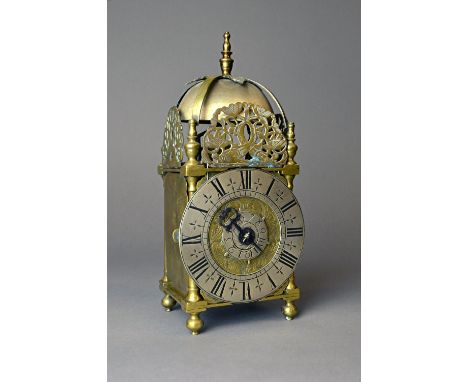 A rare brass miniature lantern timepiece with alarmLate 17th / early 18th centuryThe posted frame surmounted by a turned fini