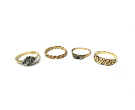 A 9ct gold, emerald and diamond set three stone ring, a gold and colourless gem set half hoop ring, in a zigzag design, detai