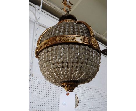 An ormolu and glass pendant ceiling light, 20th century, of globular form, with a foliate cast central band and hobnail cut g