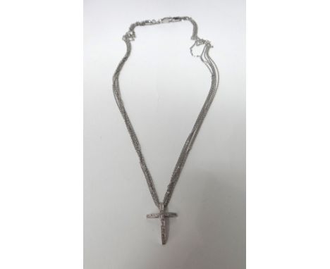 A white gold and diamond set pendant cross, in a curved design, mounted with circular cut diamonds, detailed 18 K, on a white