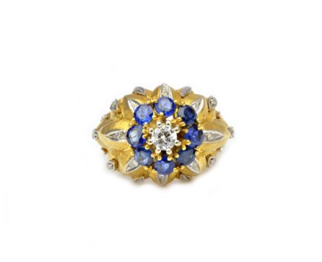 A gold, diamond and sapphire set flowerhead shaped cluster ring, claw set with the principal circular cut diamond at the cent