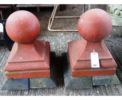 A pair of early 20th century terracotta gate spheres on swept moulded socles, 36cm wide x 50cm high, (2). 