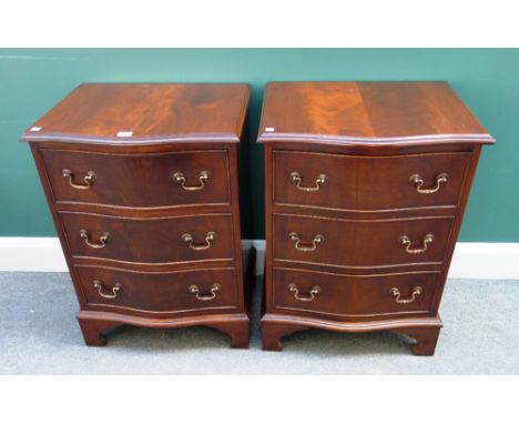 A pair of 20th century mahogany serpentine three drawer bedside chests on bracket feet, each 52cm wide x 42cm deep (2). 