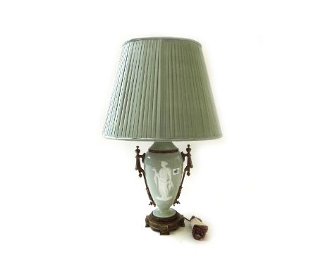 An ormolu mounted pate sur pate celadon ground table lamp, 32cm high, with shade.