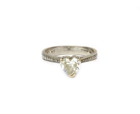 An 18ct white gold and diamond ring, claw set with the principal heart shaped diamond at the centre, between diamond set ten 