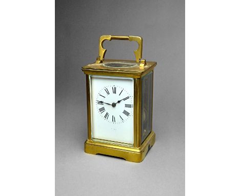 A French brass carriage clock By Couaillet, circa 1910In a Corniche case, the white enamel dial with Roman chapters, the twin