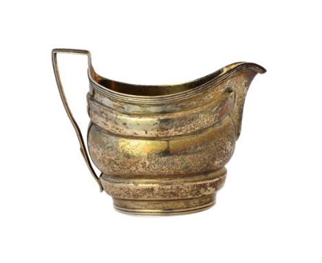 A George III silver milk jug, of helmet shaped form, decorated with reeded bands and with an angular handle, London 1802, wei