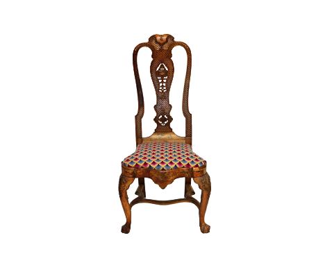 A George III stripped walnut side chair, with scale and anthemion carved high back over shaped seat and carved support, on cl