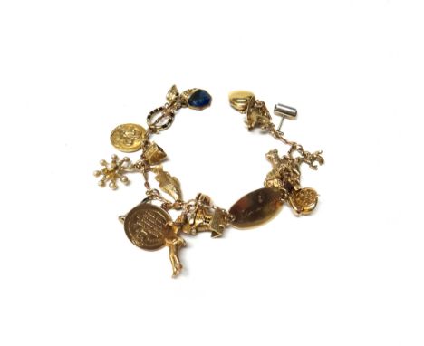 A gold identity charm bracelet, fitted with a variety of charms and pendants, including a green enamelled and diamond set hea
