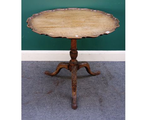 A George III mahogany occasional table, the scallop edge circular top on spiral column and carved tripod base, 84cm wide x 71