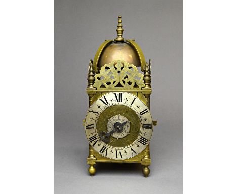 A brass miniature lantern timepiece with alarmIn the Queen Anne Style, 20th centuryThe posted frame surmounted by a turned fi