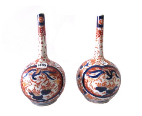 A pair of Japanese Imari bottle vases, Meiji period, painted with panels of ho-o birds above flowers, (a.f), 30.5cm. high; al