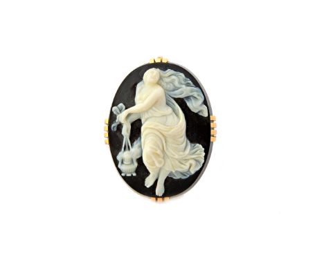 A gold mounted oval banded agate cameo brooch, carved as the figure of a classical lady, holding a lantern.  Illustrated