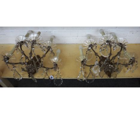 A pair of brass and glass five light wall appliques, 20th century, the brass relief cast backplates issuing five gilt metal a