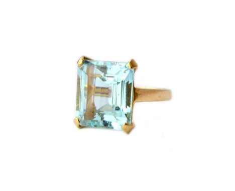 A gold ring, claw set with a cut cornered rectangular emerald cut aquamarine, detailed 14 K, ring size N.  Illustrated