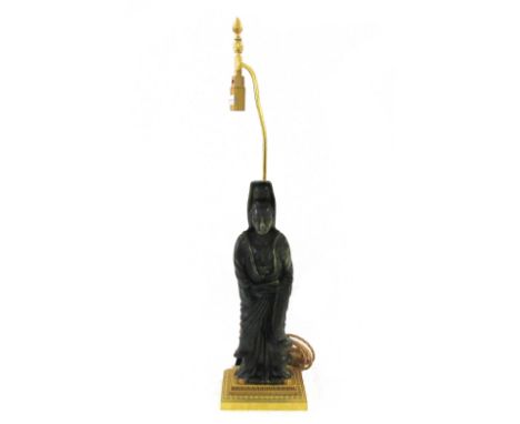 A tall Chinese spinach jade figure of Guanyin, 20th century, modelled standing in long robes holding a scroll in her left han