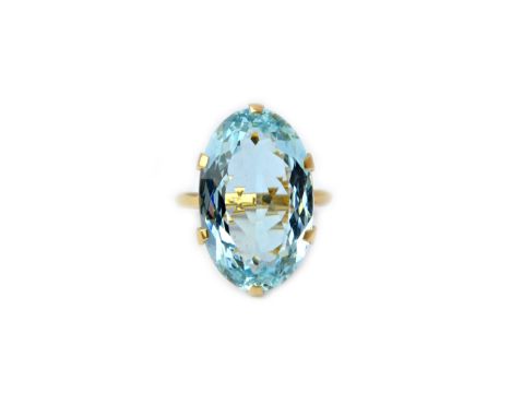 A gold ring, claw set with a large oval cut aquamarine, detailed 18 CT, ring size N and a half.  Illustrated