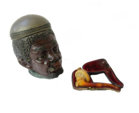 A Meerschaum pipe, late 19th century, the bowl carved as the head of a Victorian lady, 9.5cm long, cased, and a pottery and m