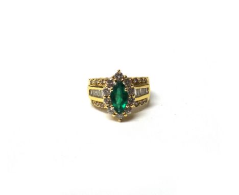 A gold, emerald and diamond cluster ring, mounted with the marquise shaped emerald at the centre, in a surround of circular c