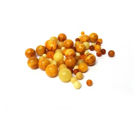A single row necklace of dark honey coloured spherical graduated amber beads, length 37.5cm, gross weight 12.5 gms, an amber 