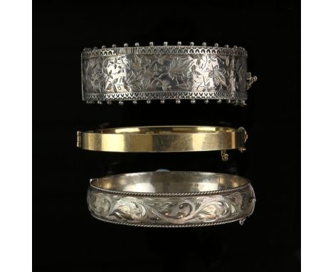 Victorian hinged bangle, engraved ivy motif, concealed clasp and safety chain, with a similar modern bangle, four bracelets, 