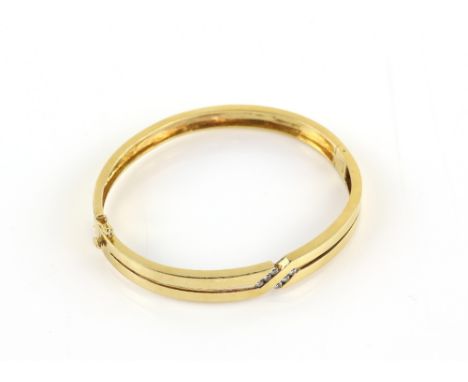 Modern diamond set oval bangle, estimated total diamond weight 0.25 carats, concealed clasp and two figure of eight safety ca