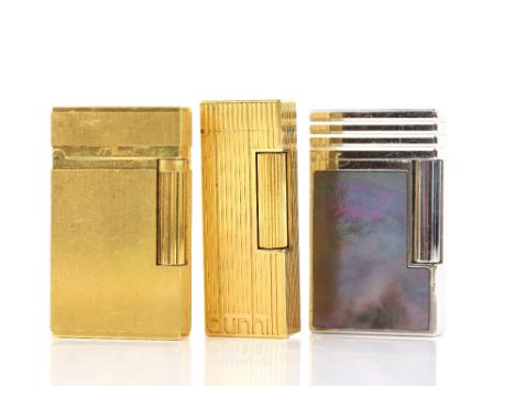 Three vintage cigarette lighters, one S.T. Dupont lighter, inlayed with black mother of pearl in white metal, no 1CUCB48, ano